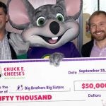 Michael Hartman, Chief Marketing Officer of Chuck E. Cheese's, presents a check to Big Brothers Big Sisters Lone Star CEO Pierce Bush.